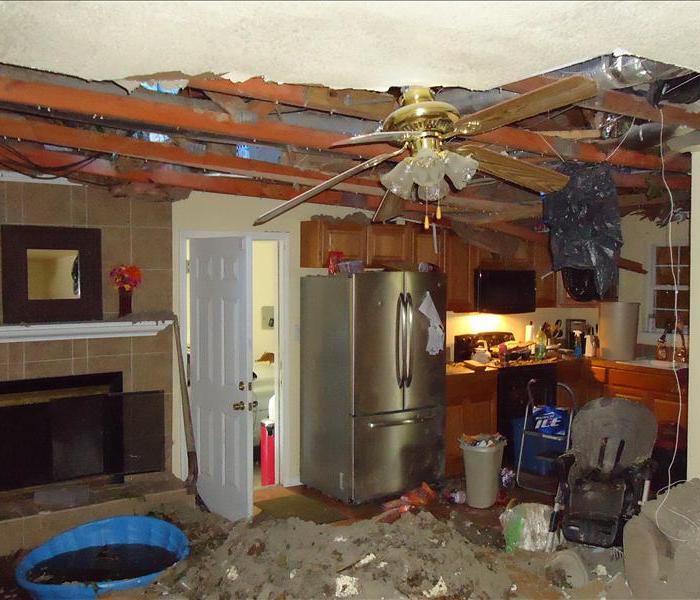 kitchen with ceiling drywall fallen down and covering the floor
