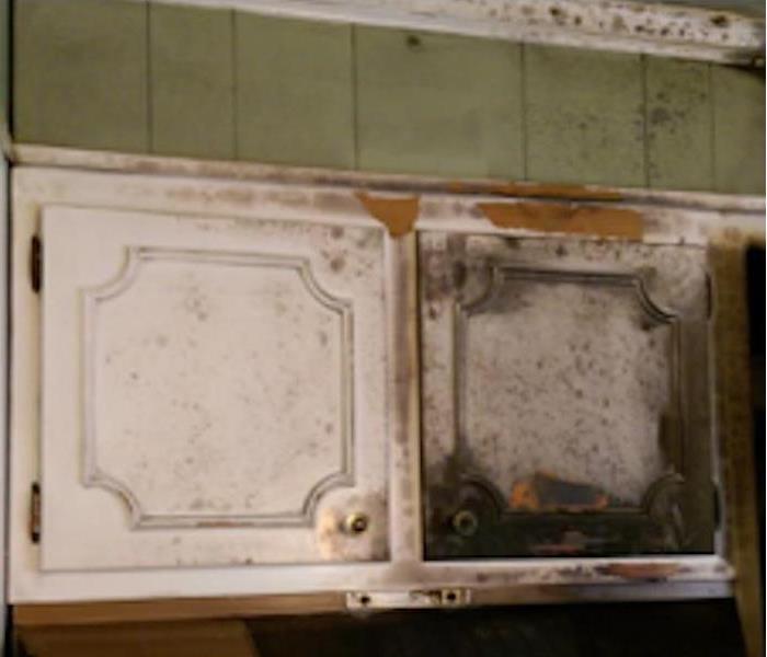 white kitchen cabinet burned and covered with soot damage