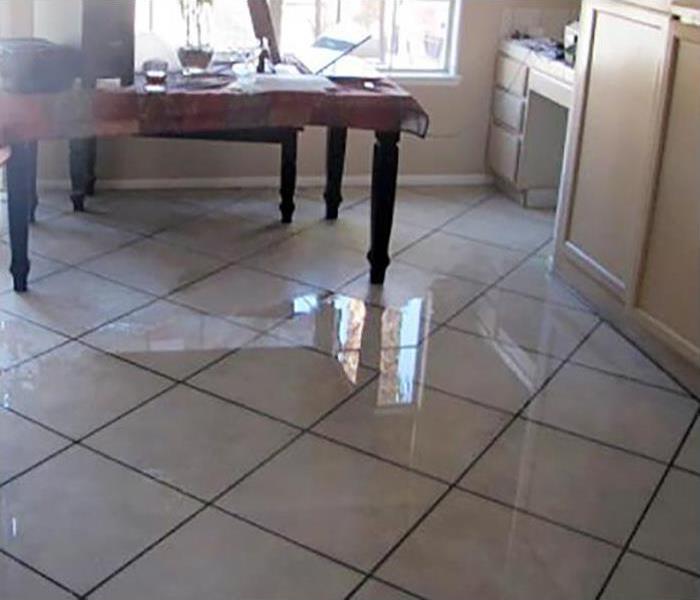 kitchen with tile floor covered in water