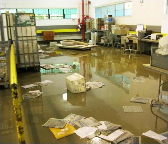 office space water covering the floor with papers and boxes littering the floor