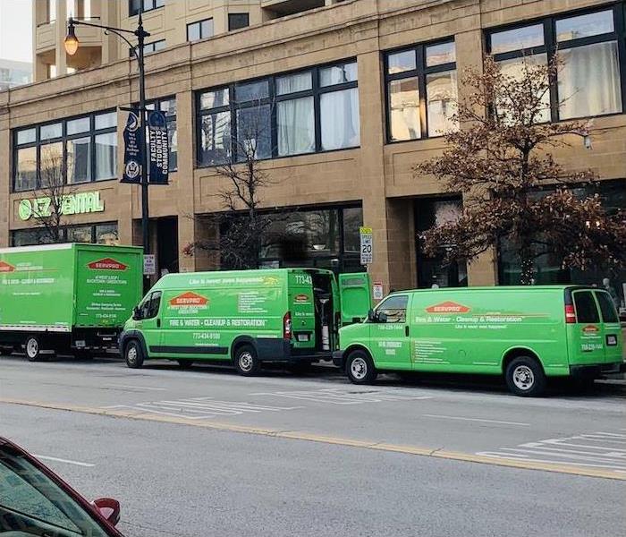SERVPRO vans and trucks parked on the street