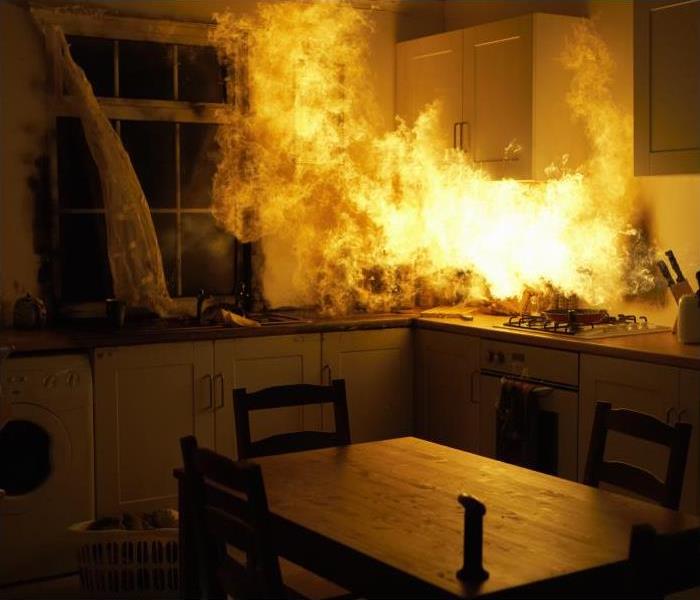fire burning on the countertops and walls of a kitchen