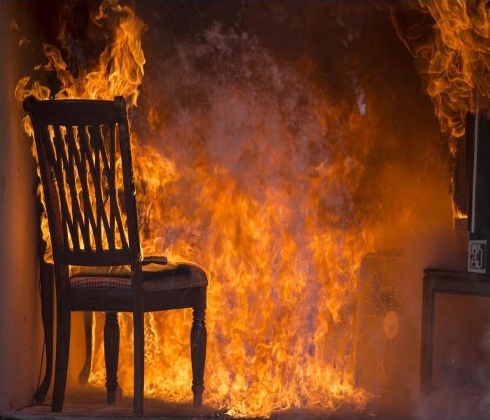 room on fire with furniture burned
