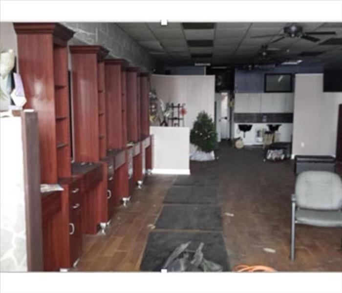 salon with wood floor and wood cabinets